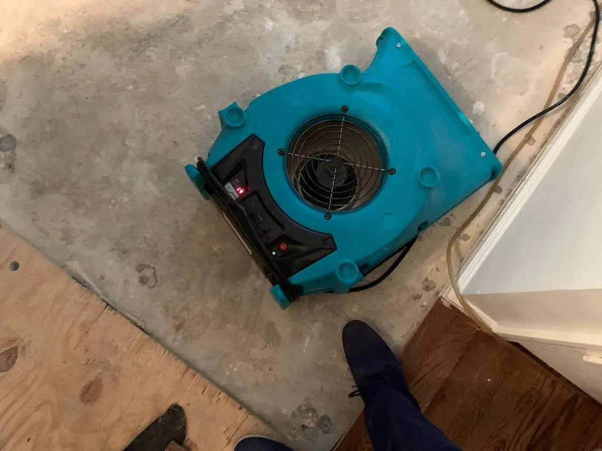 Air mover drying subfloor during Leak Detection & Repair in Boulder Hill